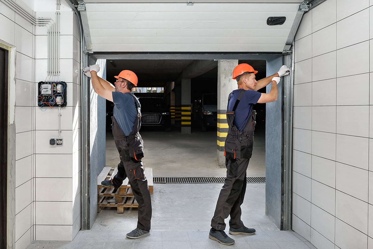 commercial-garage-door-maintenance-service 2 Workers working on Commercial Door Repair and Maintenance Services